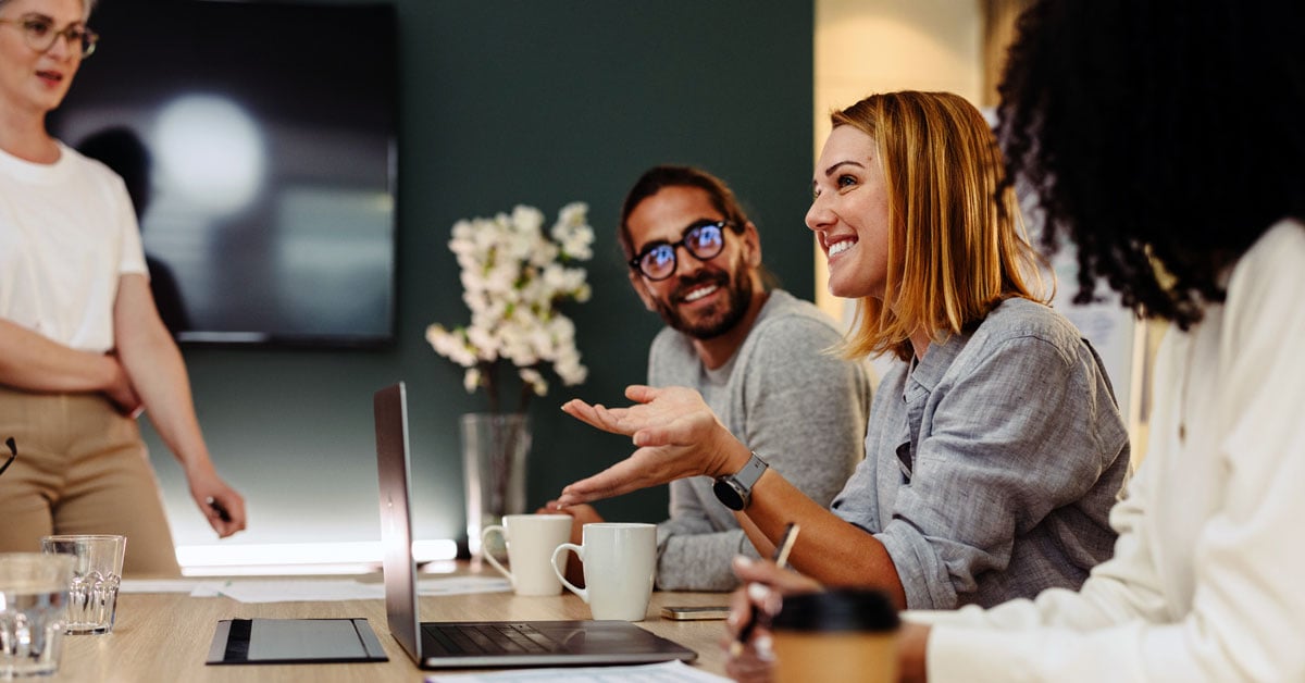 woman-talking-to-colleagues-during-meeting
